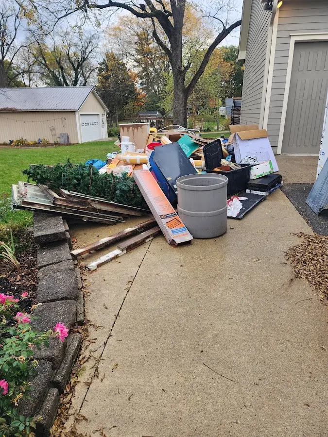 Dumpster being loaded with debris for 10 Yard Dumpster Rental in Scottdale